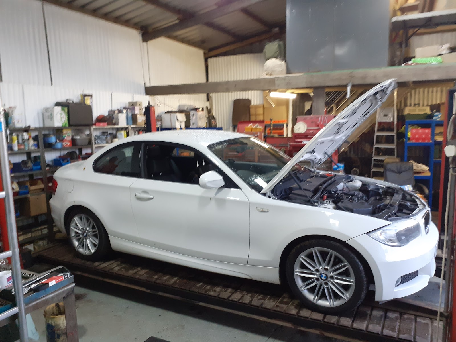 White BMW being worked on inside Bradley's Garage